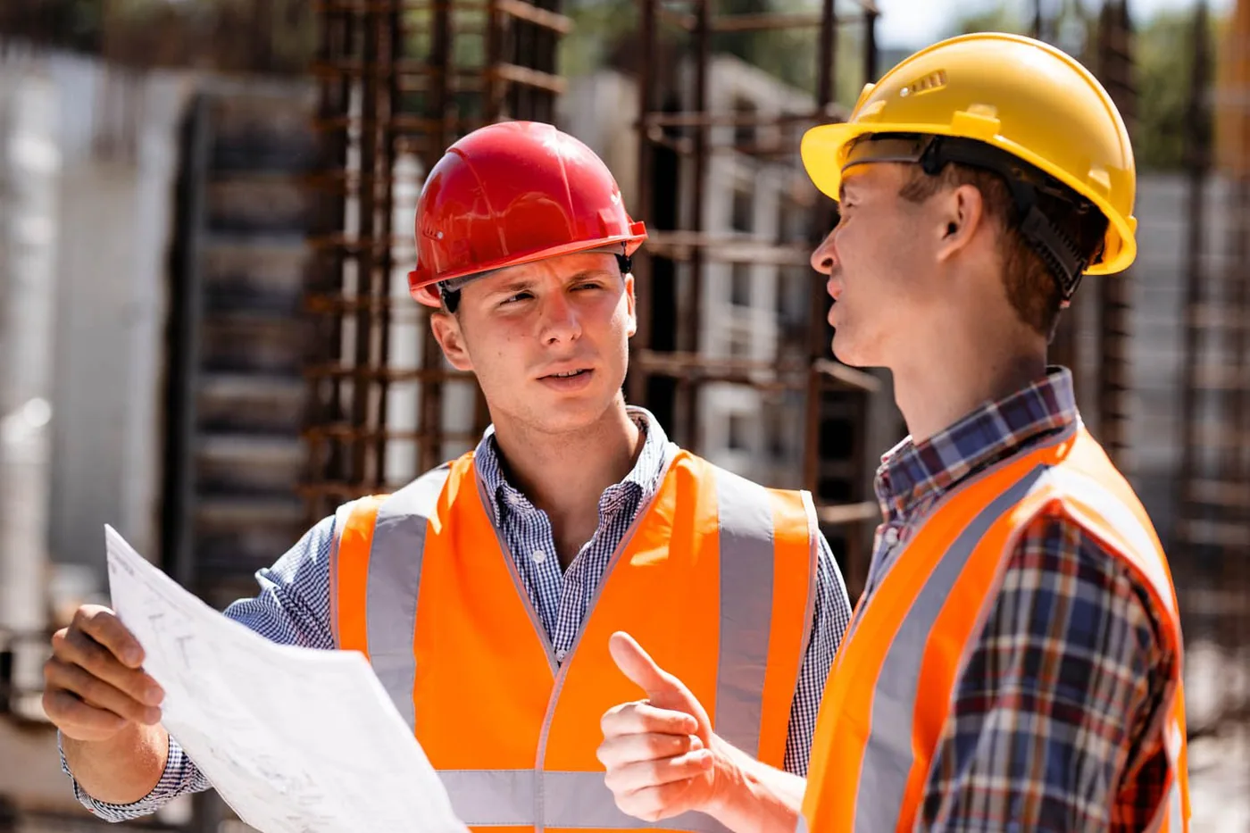 Civil engineering services team reviewing a grading and site plan on a construction site