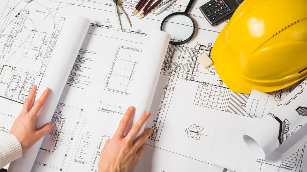 crop-architect-opening-blueprint Permit Process